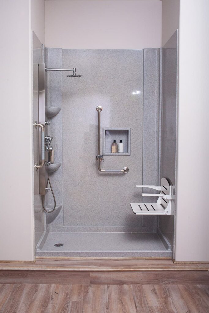 A detail shot of a senior-friendly shower equipped with grab bars and a built-in seat, promoting safety and accessibility.